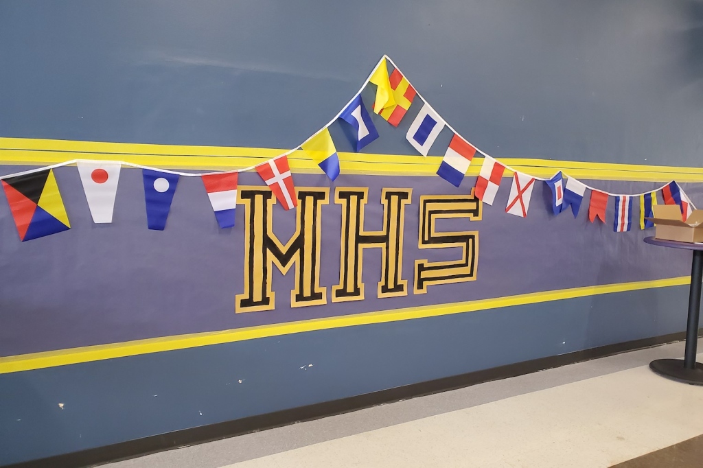 A hallway with the letters "MHS" and nautical flag decorations.